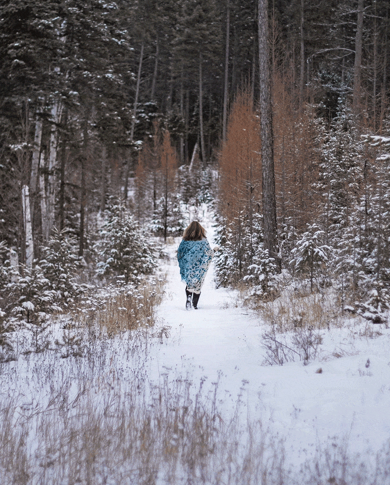 Laura walking a hill during a Montana winter